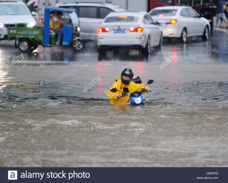 jiujiang-chinas-jiangxi-province-1st-june-2016-a-man-pushes-his-motorbike-G2PEPD.webp