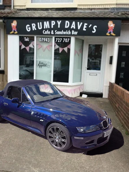 Grumpy Cafe and car.webp